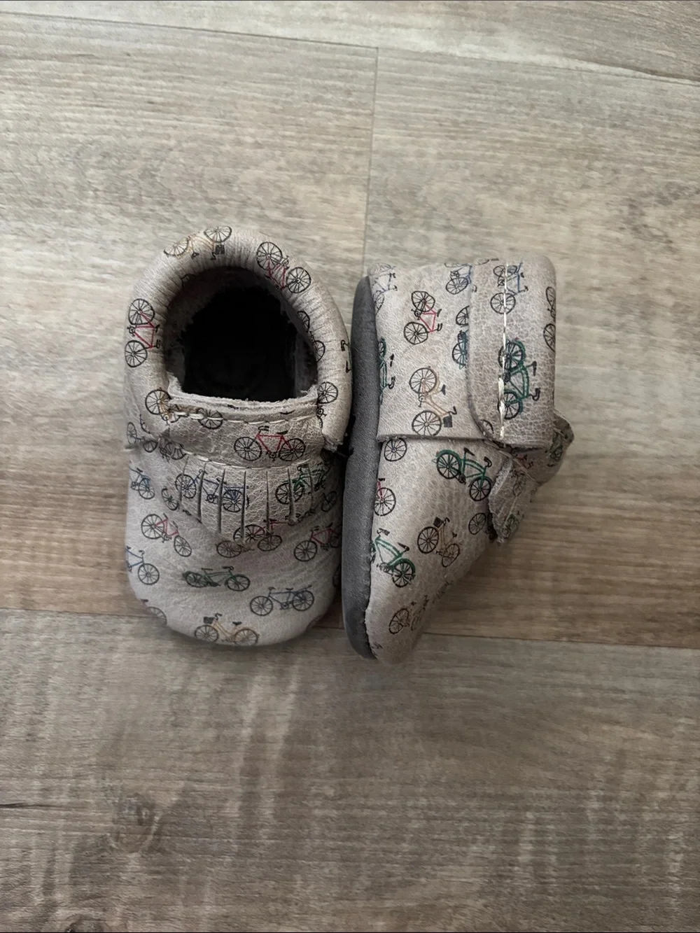 Freshly Picked Beige Baby Moccasins with Multicolor Bicycle Print